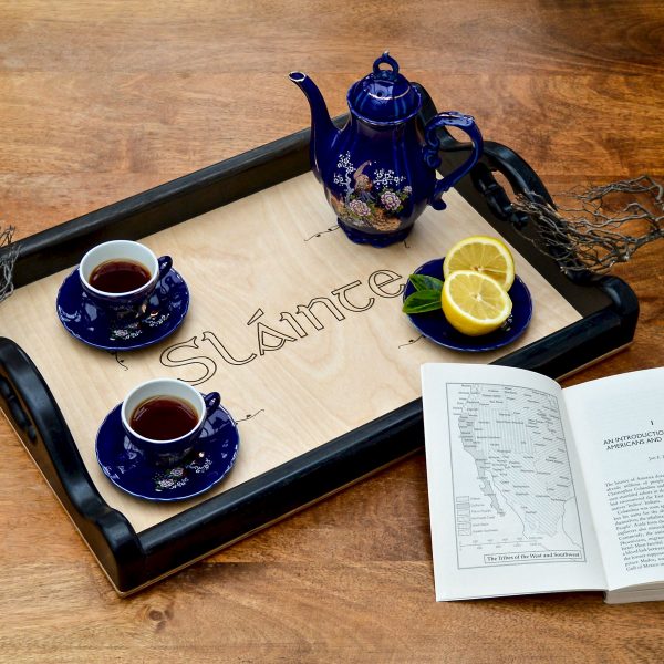 Personalised wooden servingtray engraved with the Irish word 'Sláinte'. Two blue cups and a cobalt blue Japanese tea pot on top.