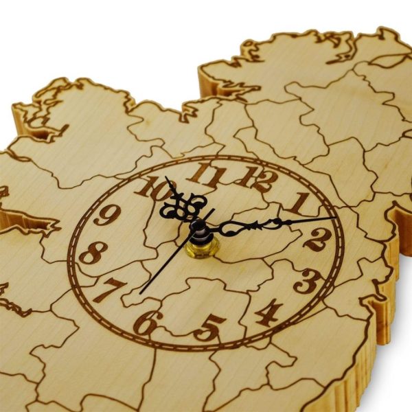 Close up of a woooden wall clock Ireland map, showing black decorative clock hands, and an engraved clock face.