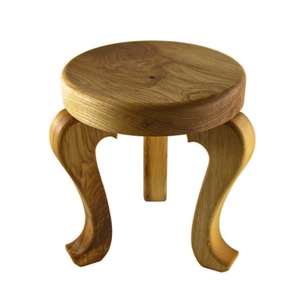 A handmade 3 legged wooden stool made from native Irish Ash wood on a white background. The seat is round and woodturned. The legs are in the Queen Ann style. The stool is about 12" tall x 10" in diameter. There is a Magill Woodcraft Ireland info card sitting on top of the wood stool.