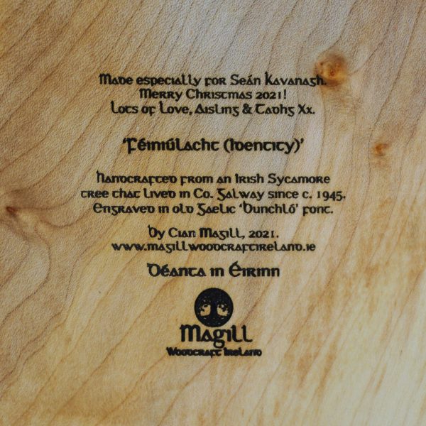 Engraved in old Gaelic font text on wood