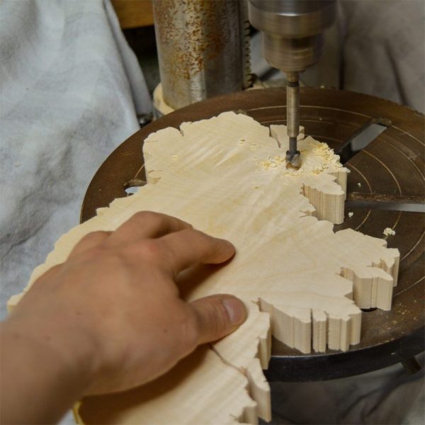 Using a pillar drill to make a hole in an Irish wooden gift wall map.