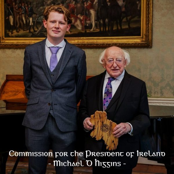 President Michael D. Higgins holding a handcrafted wooden map of Ireland created by Magill Woodcraft Ireland.